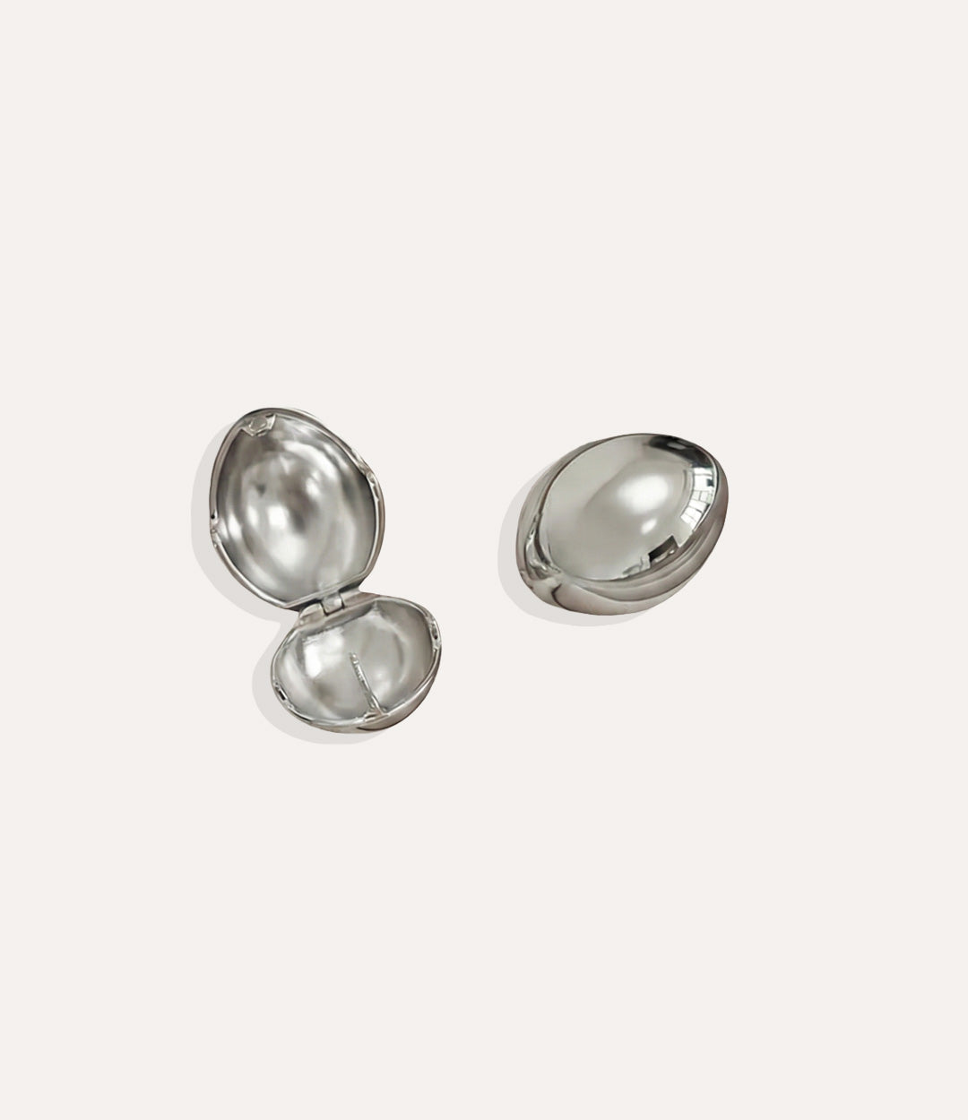 Product shot of the Bianca Earrings in a silver colour showing the cool metallic shine and modern twist shape on a white background.