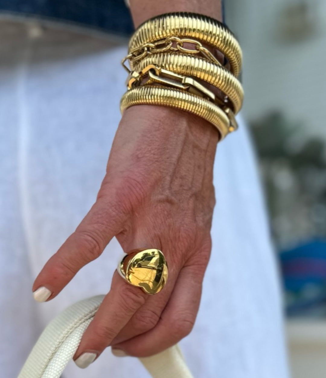 Woman's hand modeling the Big Love Ring on the ring finger, showcasing the bold chunky heart signet design.