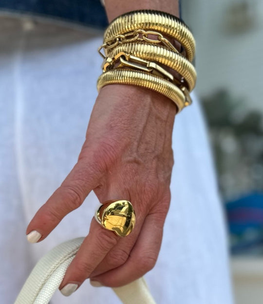 Woman's hand modeling the Big Love Ring on the ring finger, showcasing the bold chunky heart signet design.