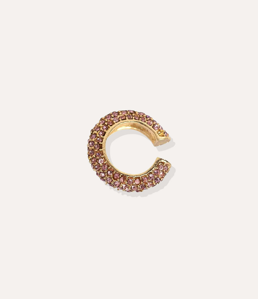 Close up of the Bling Ear Cuff in gold highlighting the vibrant pink diamonds and sleek finish.