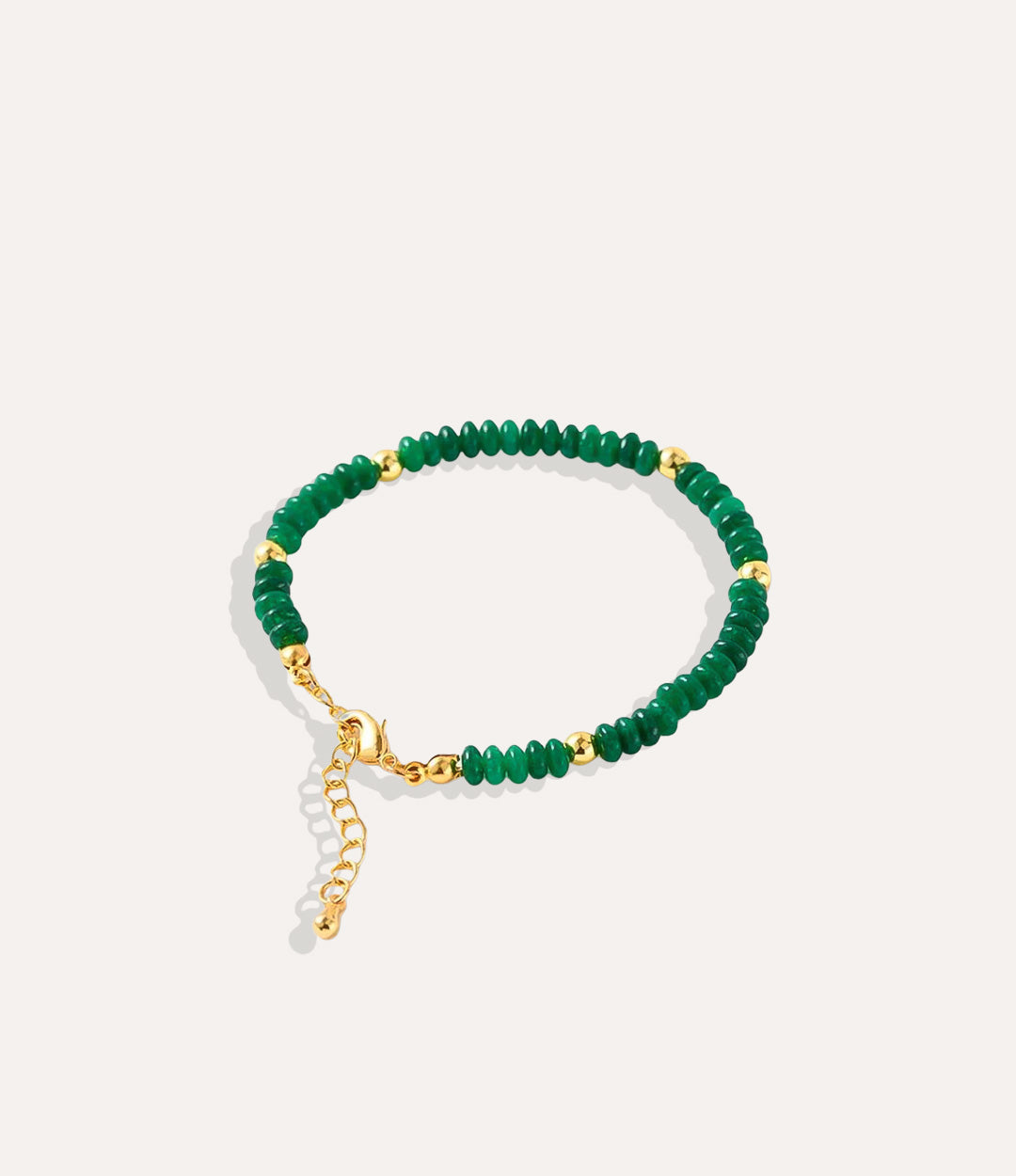 Boho Beaded Bracelet made with natural jade stones, crystals, and 18k gold-plated brass displayed on a neutral background