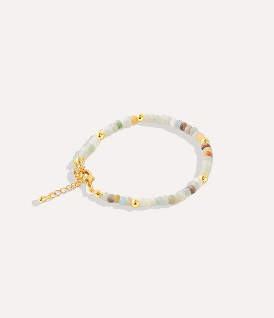 Boho Beaded Bracelet made with natural multi stones, crystals, and 18k gold-plated brass displayed on a neutral background