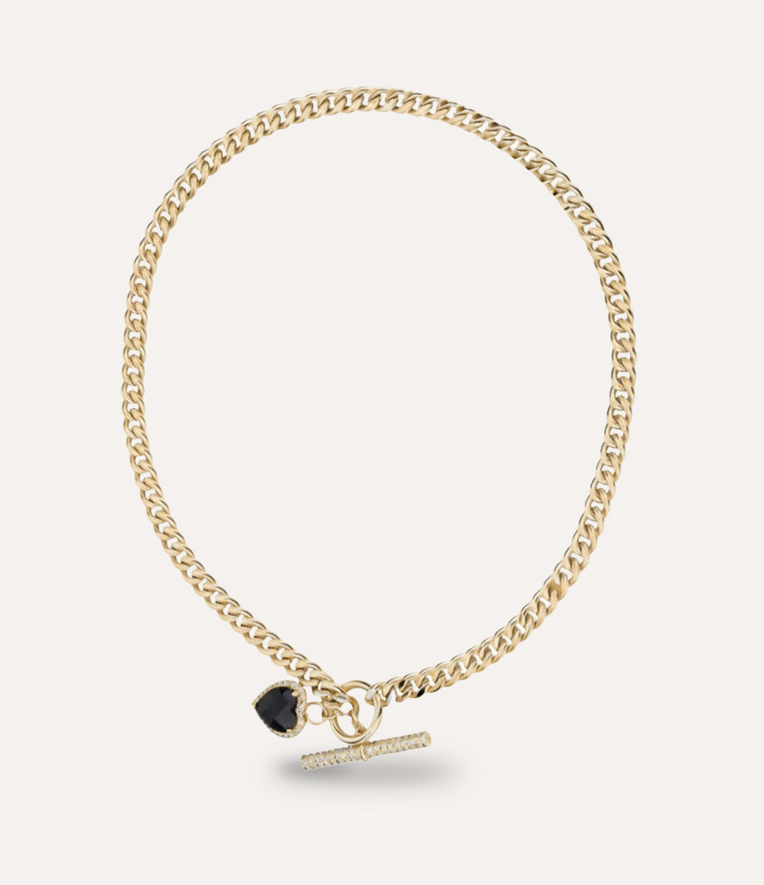 Gold chain bracelet with a black heart gemstone charm on a light gray background