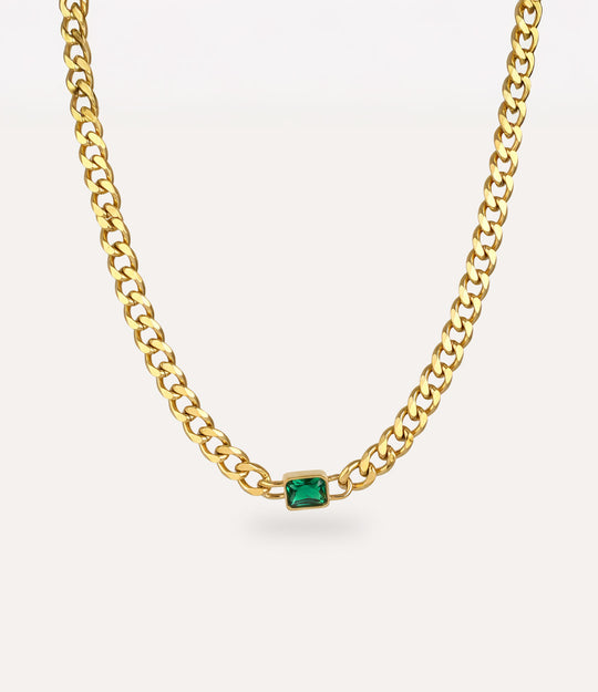 Chunky gold solitaire chain necklace with vintage-inspired green pendant on white background