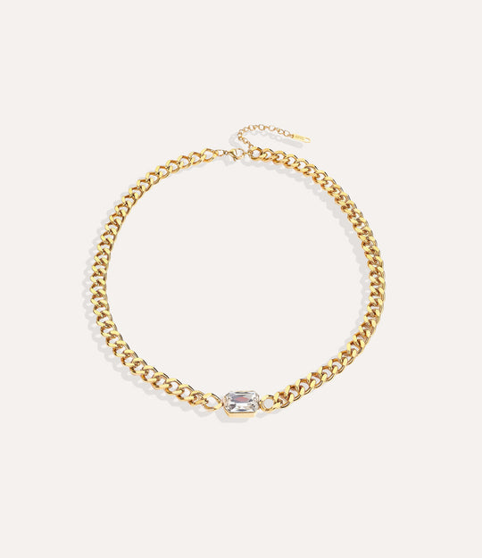 Chunky gold solitaire chain necklace with vintage-inspired white pendant on white background