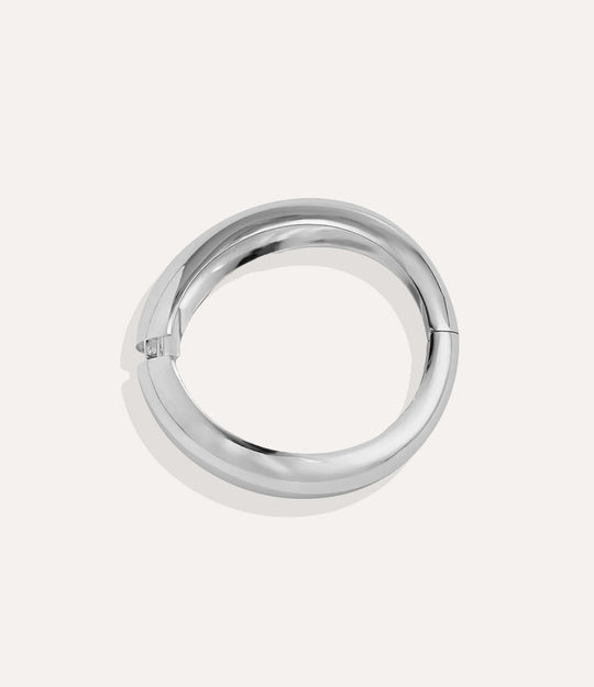 Close-up of the Classic Bangle showing its minimalist, smooth metallic design.