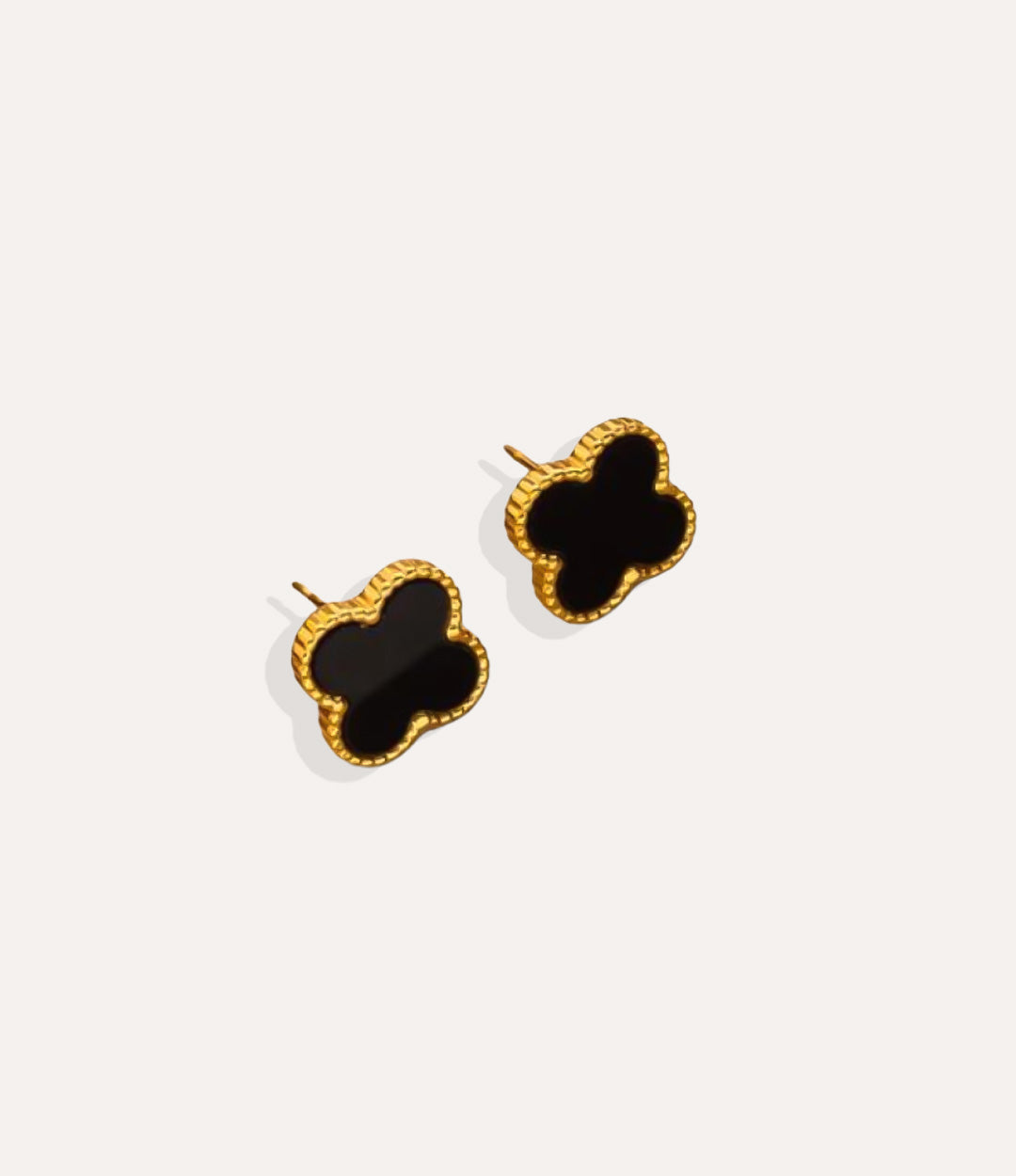 Product shot of the Clover Stud Earrings in a gold finish displaying the lucky four leaf design in black and warm metallic tone on a white background.