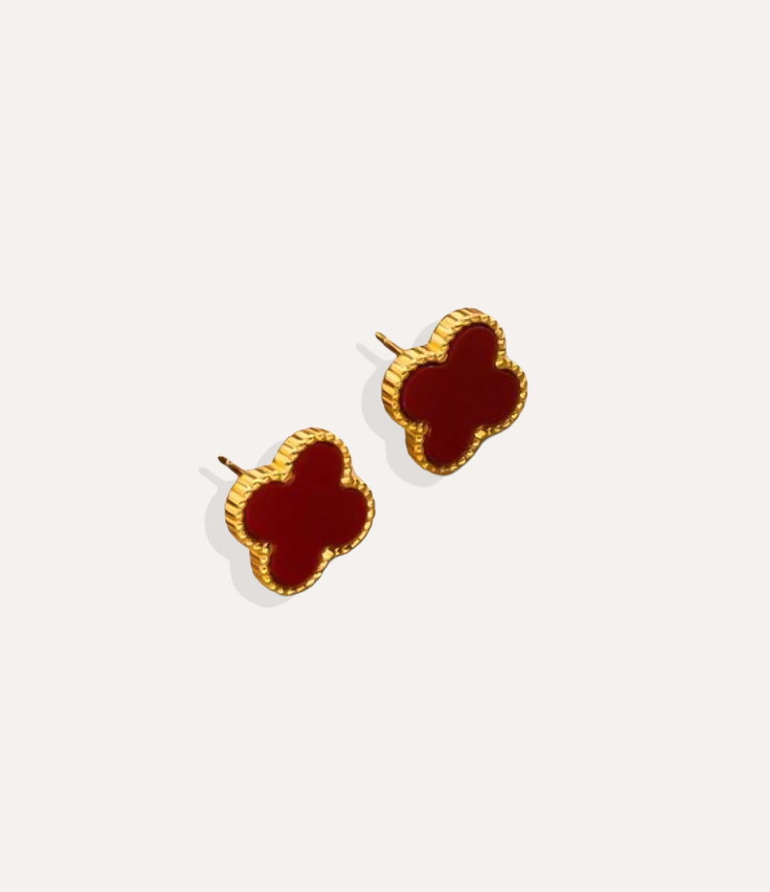 Product shot of the Clover Stud Earrings in a gold finish displaying the burgundy lucky four leaf design and warm metallic tone on a white background.