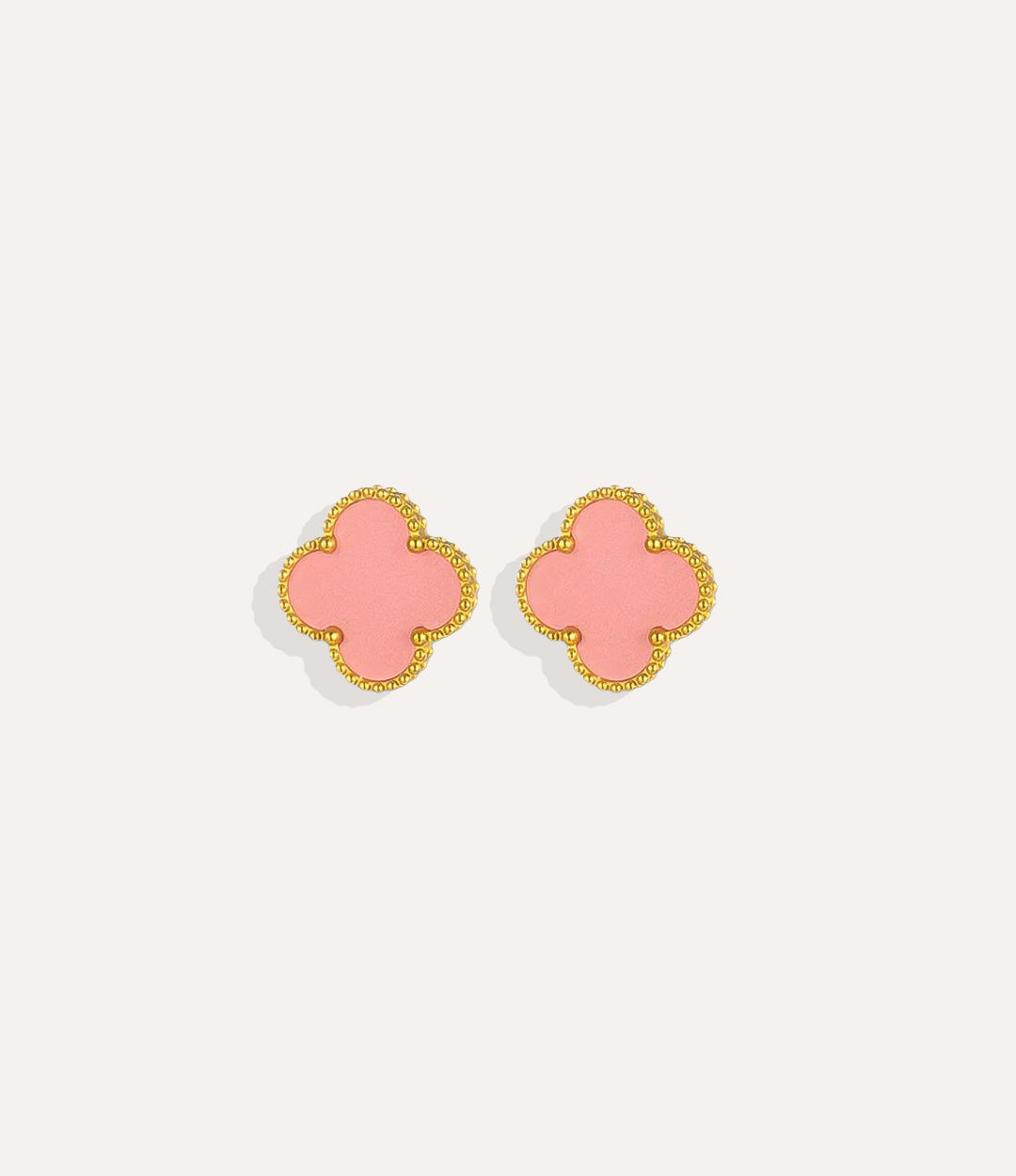 Product shot of the Clover Stud Earrings in a gold finish displaying the lucky four leaf design in pink and warm metallic tone on a white background.