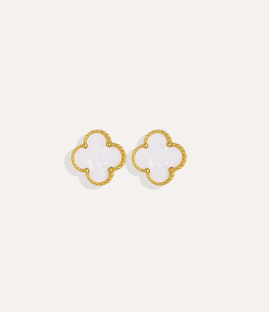 Product shot of the Clover Stud Earrings in a gold finish, displaying the lucky four-leaf design in white and warm metallic tone on a white background.