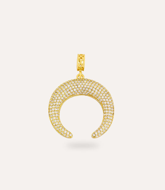 Gold crescent-shaped pendant with embedded stones on a light beige background