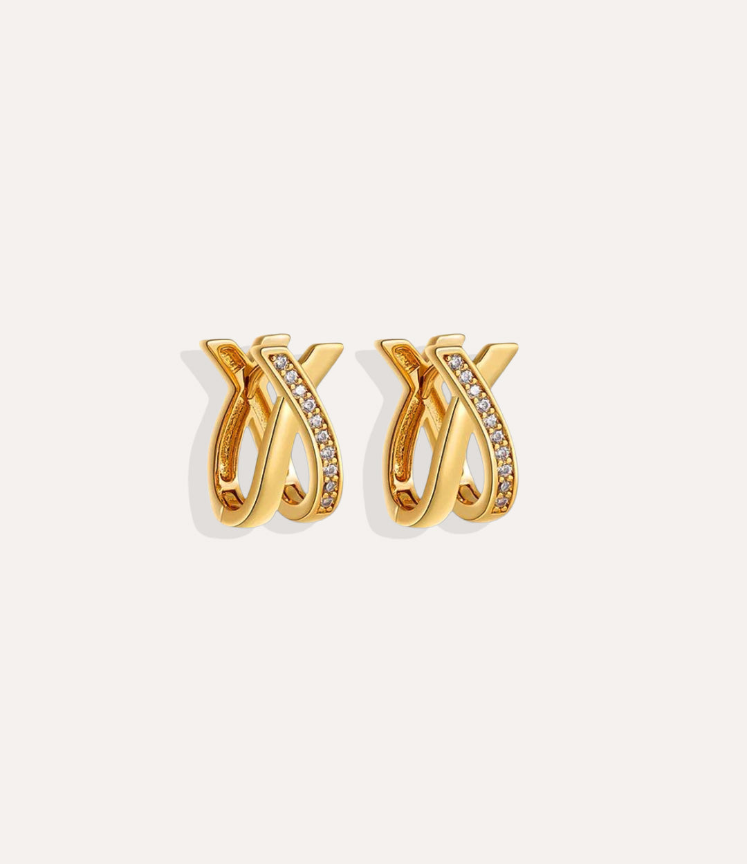 Close up of the Criss Cross Diamond Earring in gold featuring the criss-cross design with a sparkling diamond detail.