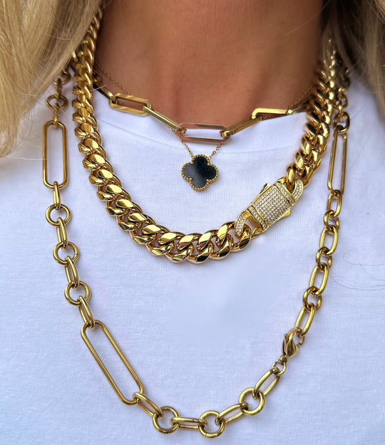 Styled photo of the 16-inch Cuban Diamond Clasp Necklace layered with other gold necklaces