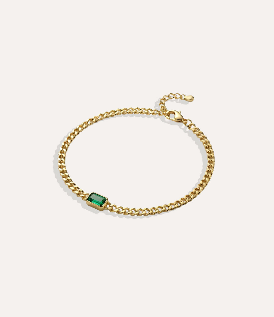 Dainty Solitaire Green Chain bracelet with a delicate chain and green stone displayed on a neutral background.