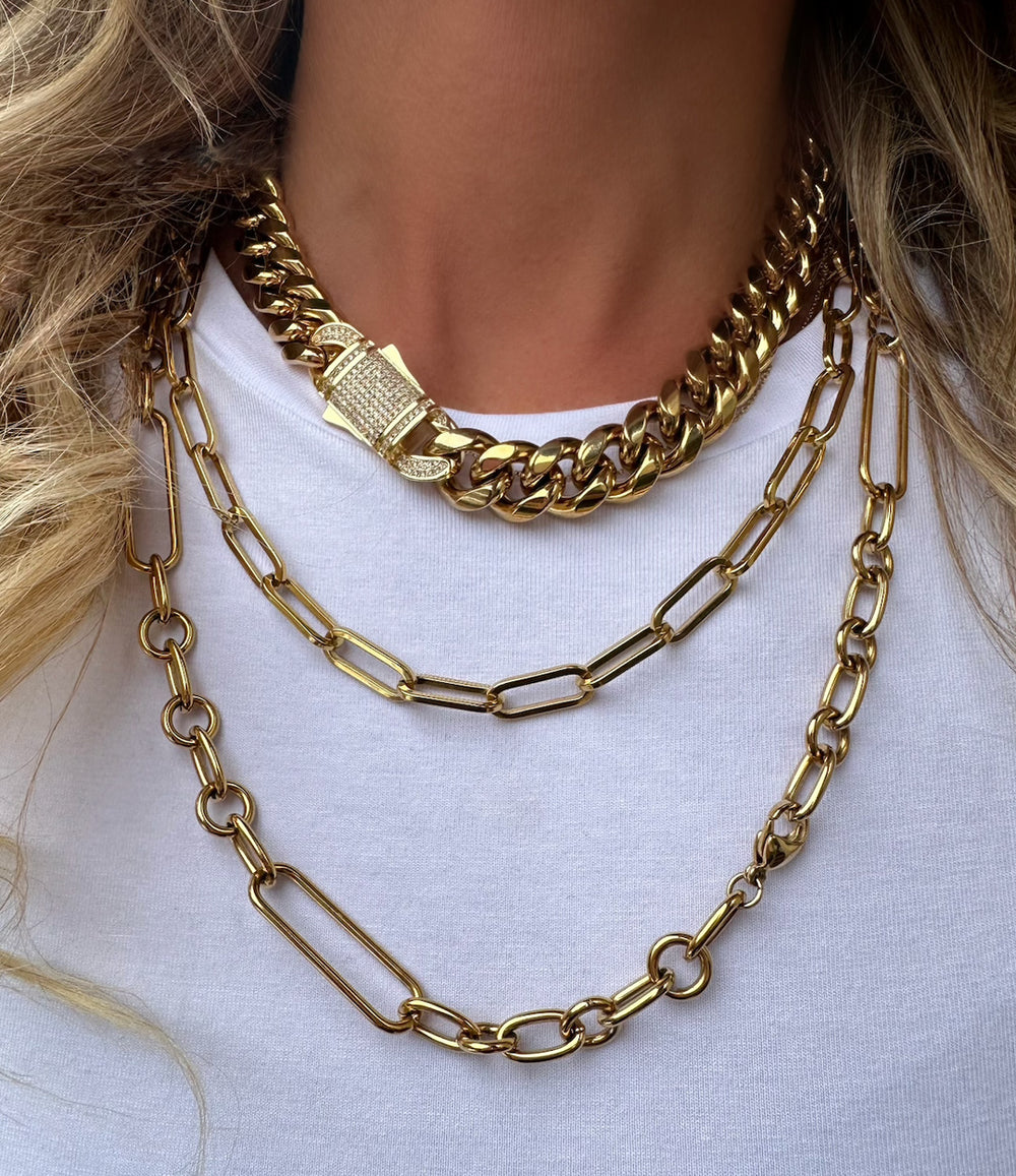Styled shot of the Daisy Chain Necklace layered with other gold necklaces