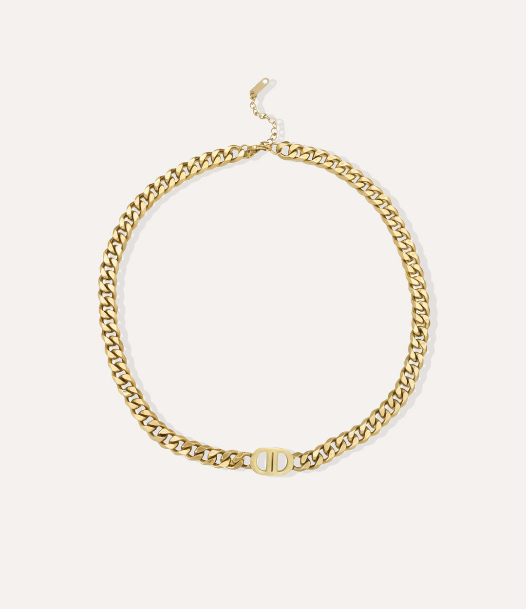 Gold chain necklace on a neutral background