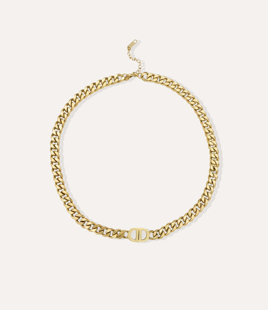 Gold chain necklace on a neutral background