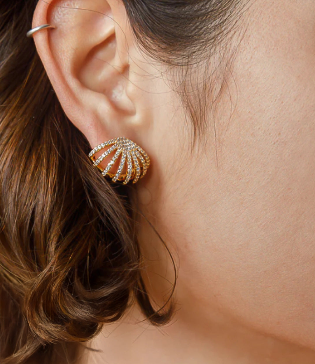 Close up of the Diamond Cage Earring in gold, highlighting the detailed cage structure and shimmering diamonds.