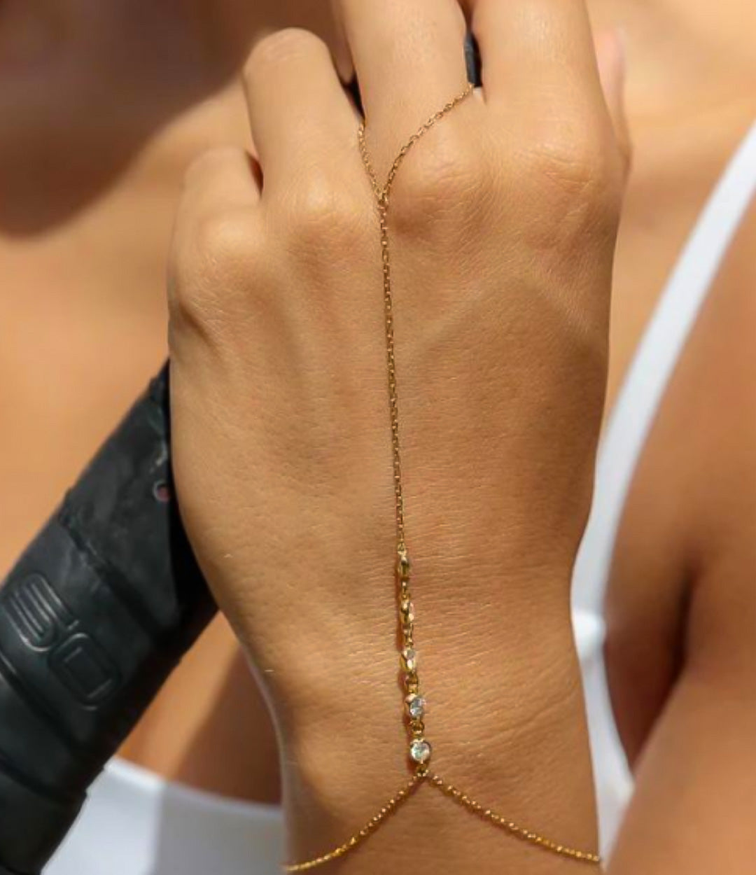 Diamond Hand Chain in gold made of sterling silver with delicate diamond details displayed on a neutral background