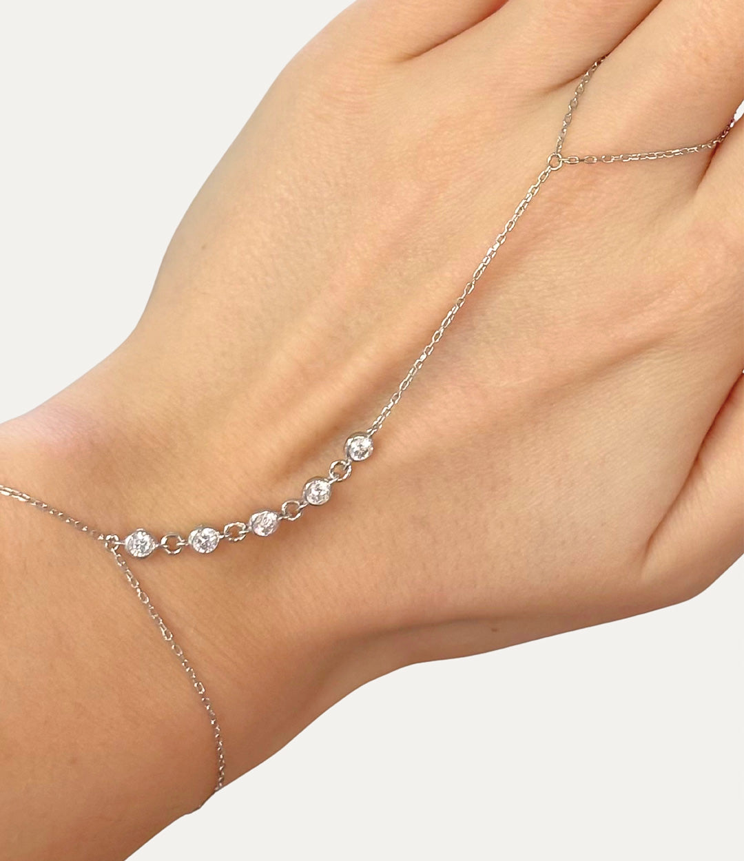 Diamond Hand Chain in silver made of sterling silver with delicate diamond details displayed on a neutral background.