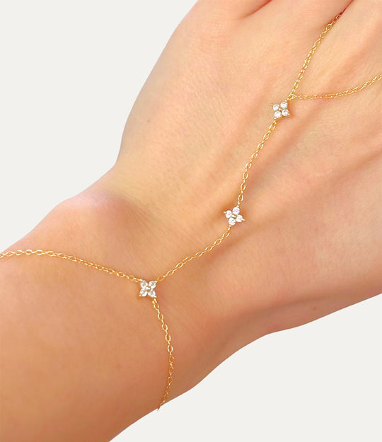 Diamond Star Hand Chain in gold made of sterling silver with delicate diamond details displayed on a neutral background