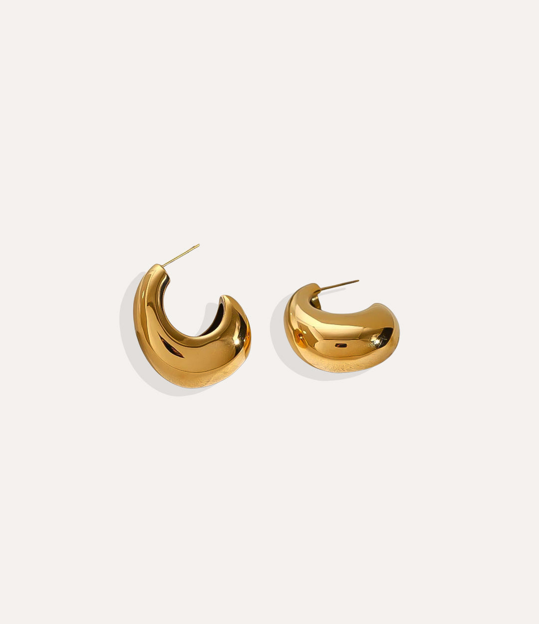 Product shot of the Dolce Vita Hoops in 18k gold plating displaying the artistic curved silhouette and smooth finish on a white background.