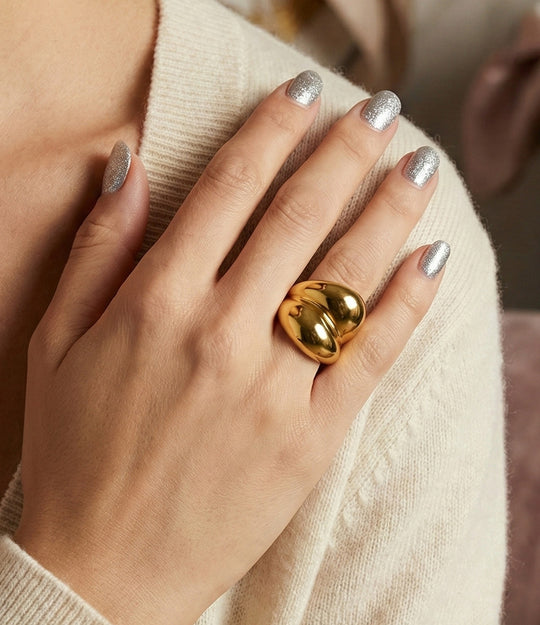Model wearing a double Stack Ring in 18k gold plated finish and silver, featuring a thick dual-band design made of waterproof stainless steel.