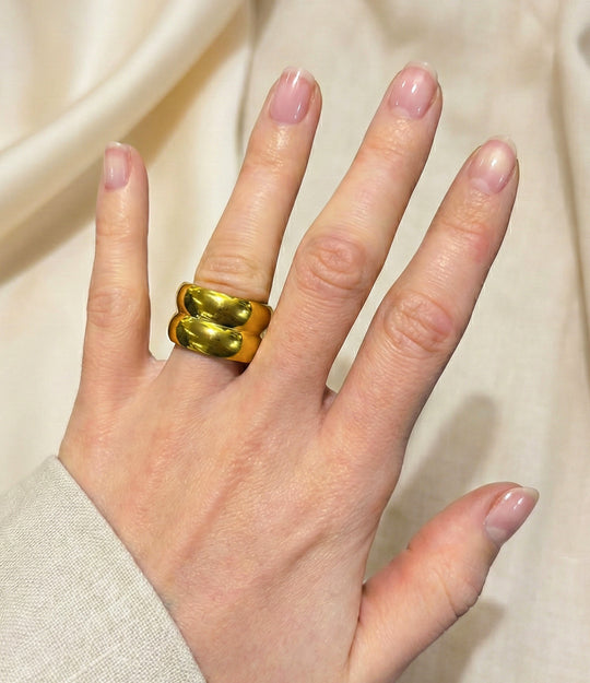 Model wearing double Trouble Ring in 14k gold-plated finish, featuring a thick, solid band design isolated on a plain background.