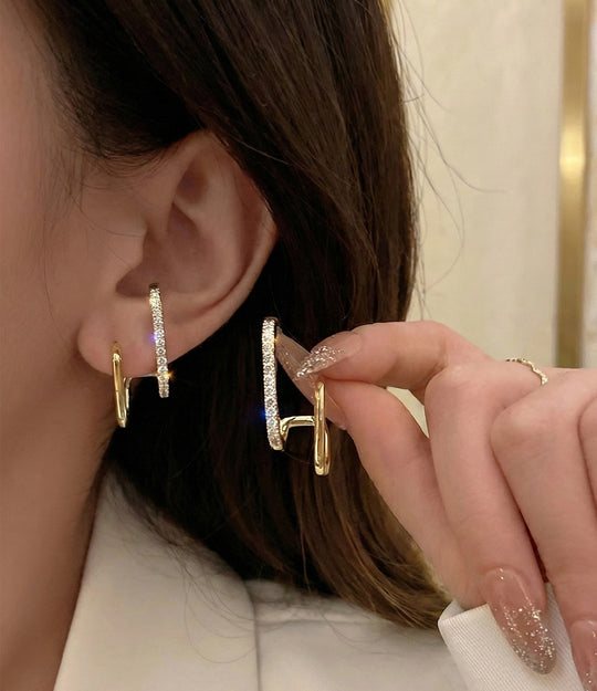 Model wearing the Double Diamond Hoop earrings showcasing the dainty double-hoop design and sparkling diamond accents.