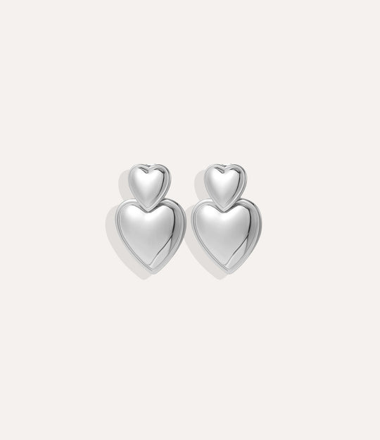 Product shot of the Double Heart Earrings in silver colour showing the cool stainless steel tone and double drop design on a white background.