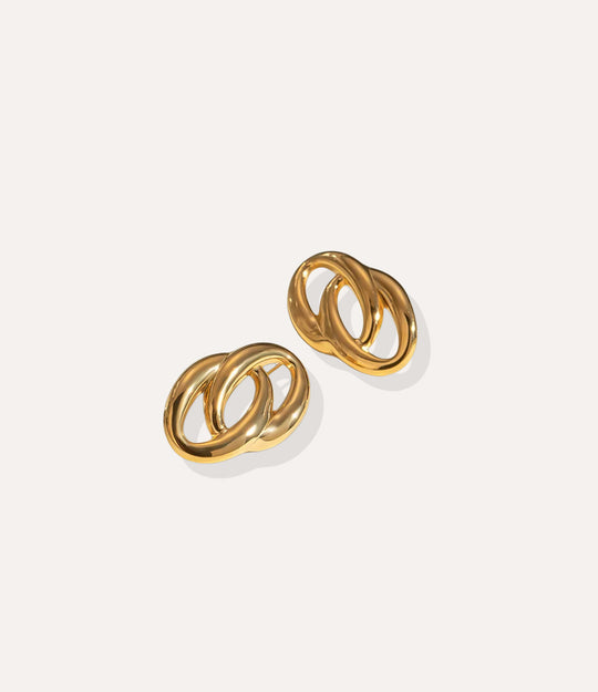 Close up of the Double Link Earrings in gold, highlighting the polished stainless steel and modern linked silhouette.