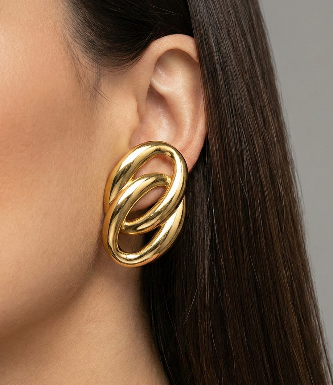 Model wearing the Double Link Earrings, showcasing their oversized intertwined link design and bold statement look.