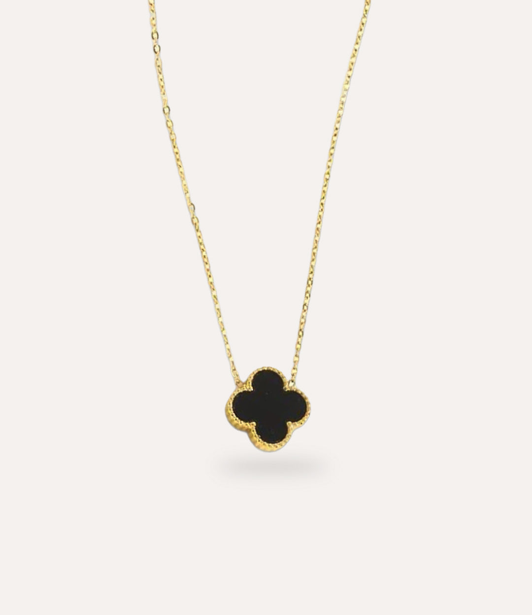 Double Sided Black Clover Necklace in gold plating displayed on a clean neutral background