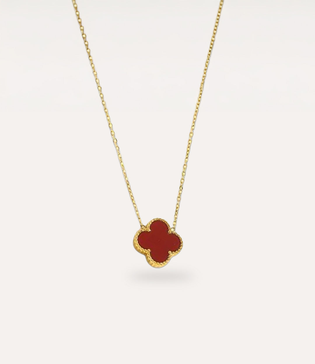 Double Sided Burgundy Clover Necklace in gold plating displayed on a clean neutral background