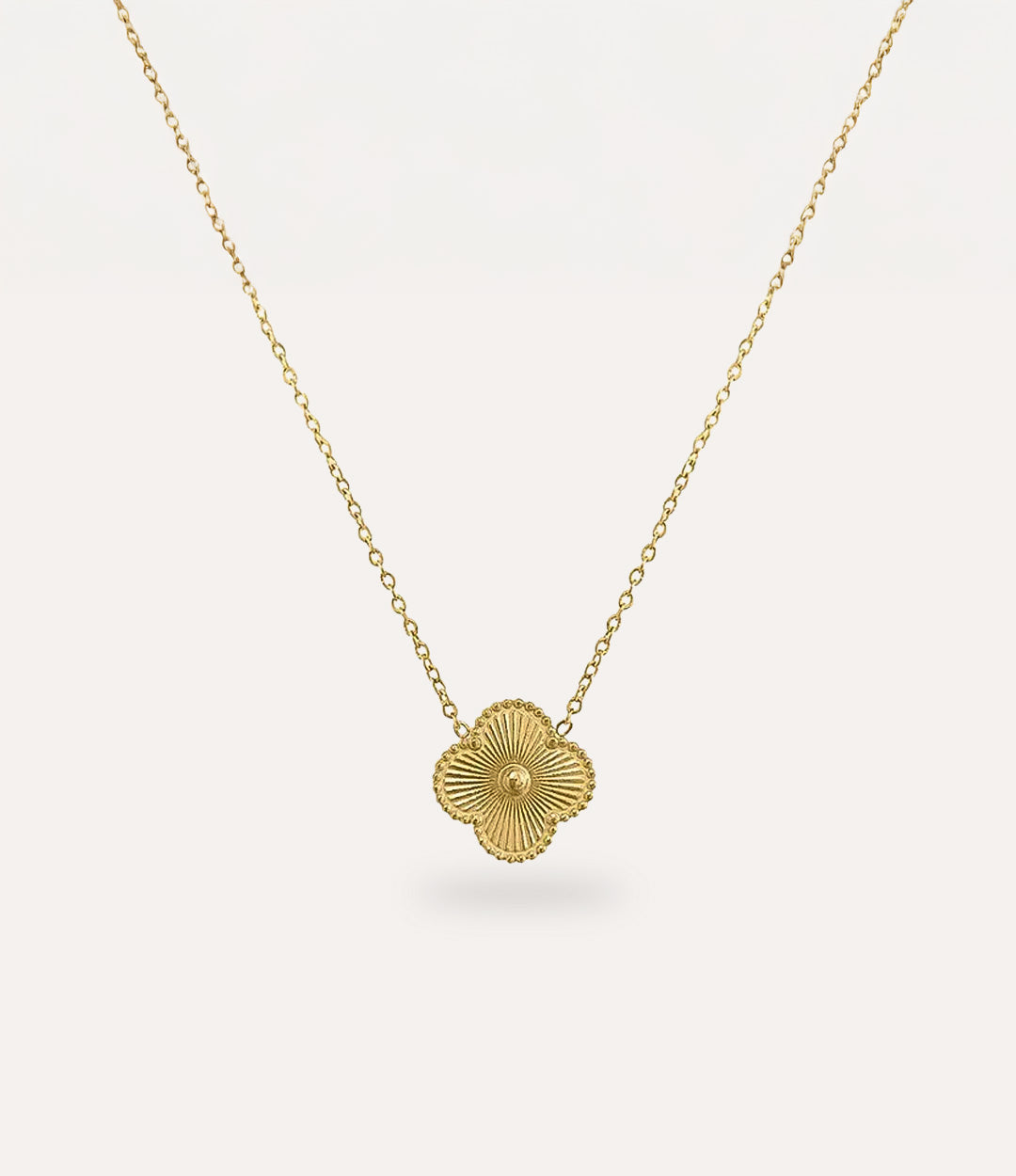 Double Sided Clover Necklace in gold plating displayed on a clean neutral background