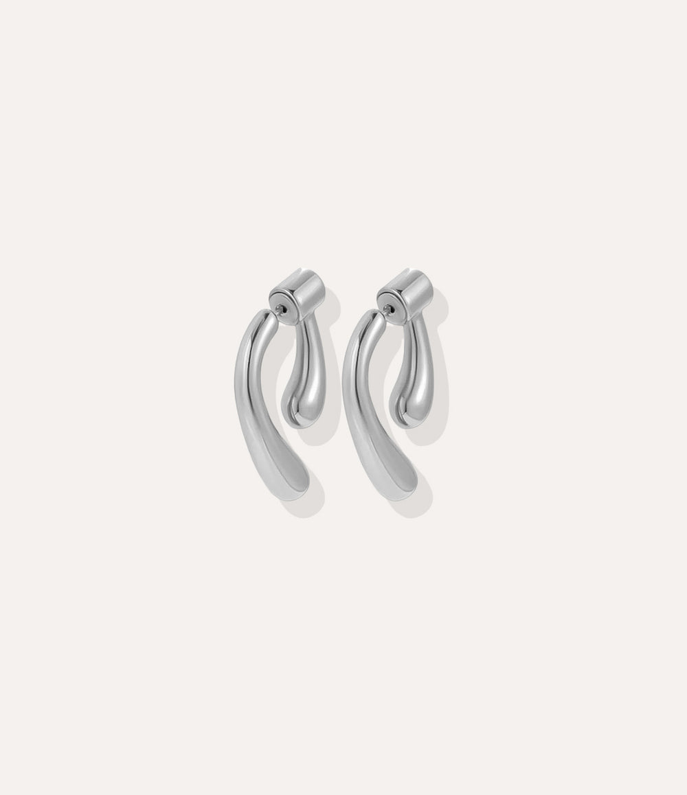 Close up of the Double Sided Drop Earrings in silver, featuring the shiny silver finish and stylish drop silhouette.