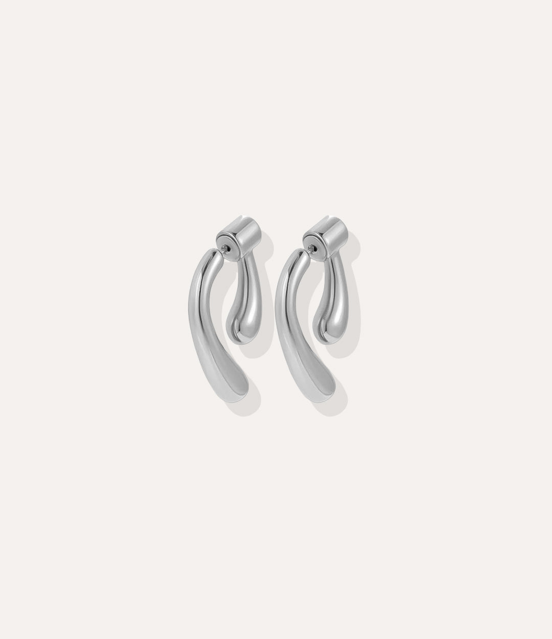 Close up of the Double Sided Drop Earrings in silver, featuring the shiny silver finish and stylish drop silhouette.