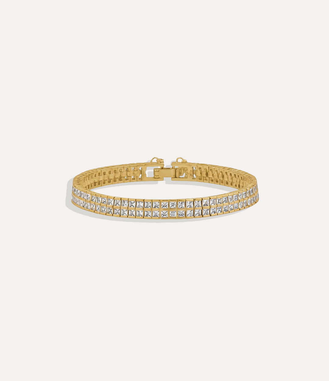 Double Tennis Bracelet with two rows of princess-cut diamonds on a gold band displayed on a clean background