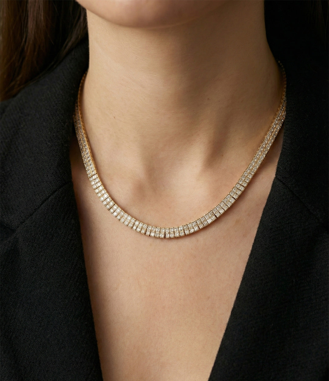 Necklace with diamonds on a person wearing a black outfit