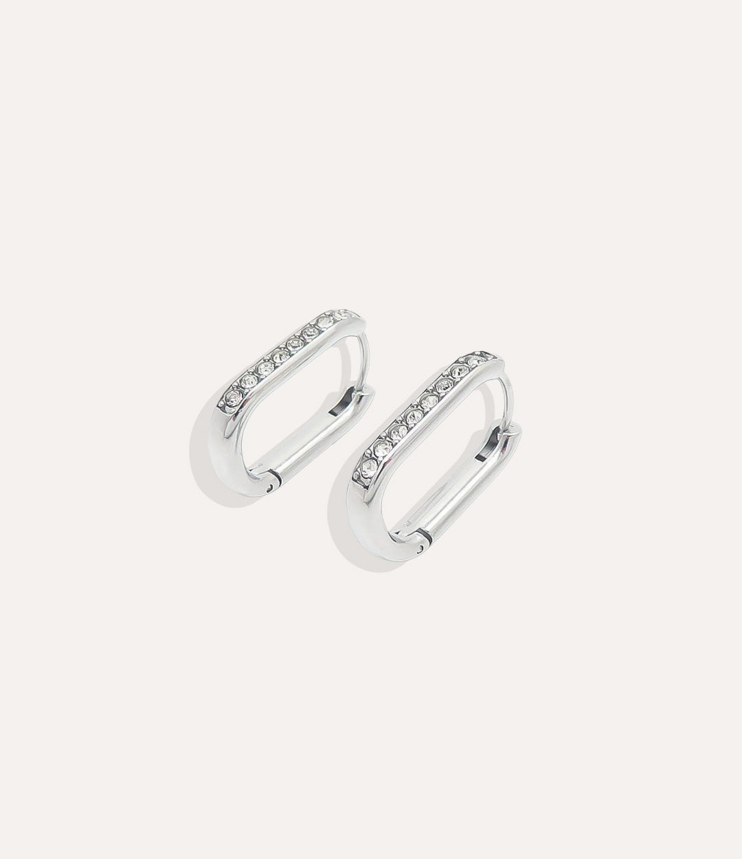 Pair of silver hoop earrings with small stones on a white background