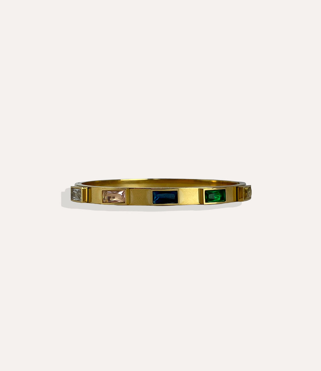Gold bracelet with embedded gemstones on a white background