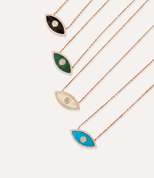 Set of four necklaces with eye-shaped pendants on a white background