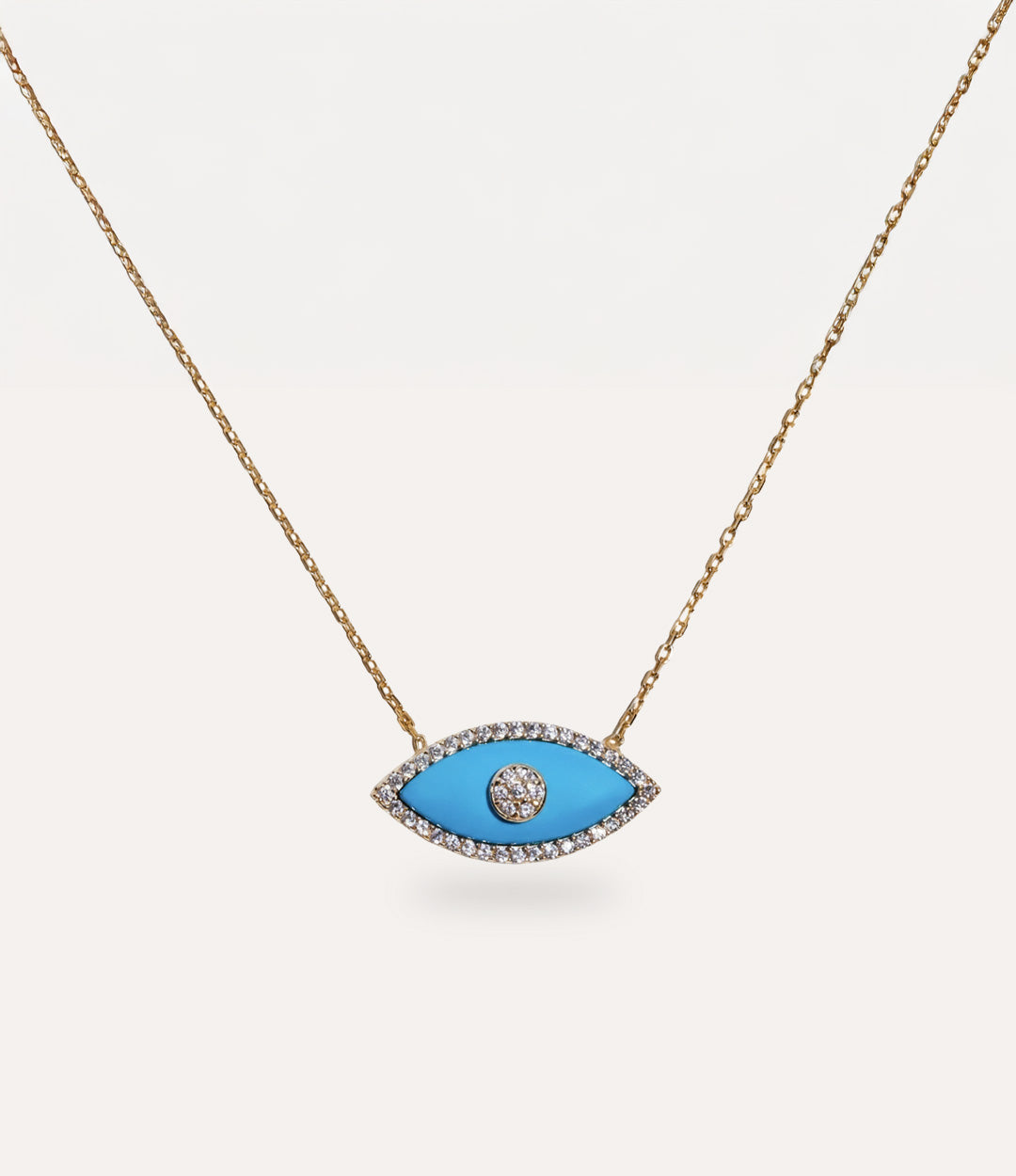 Gold Enamel Evil Eye Necklace in turquoise on display