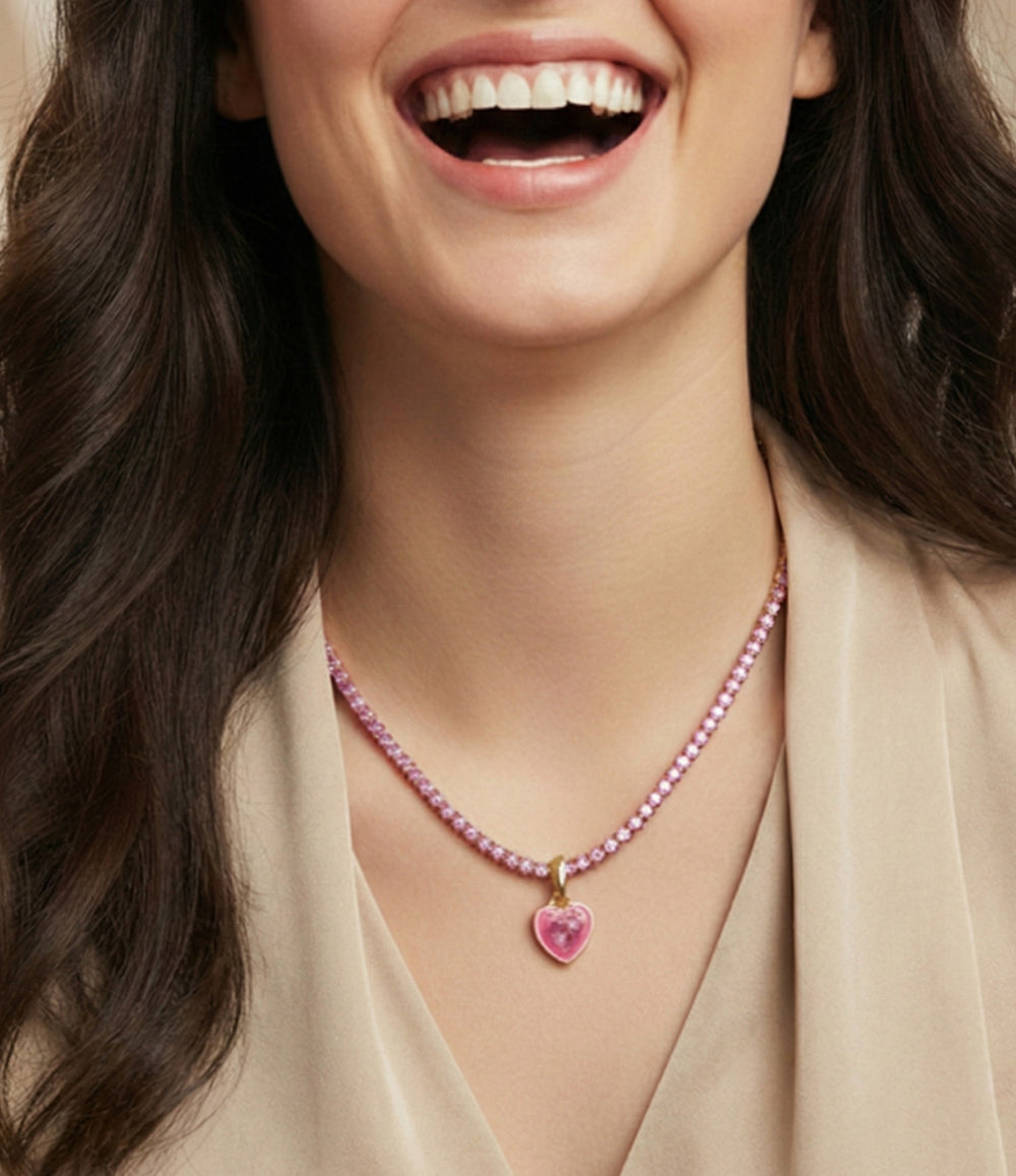 Woman wearing a pink beaded necklace with a heart pendant
