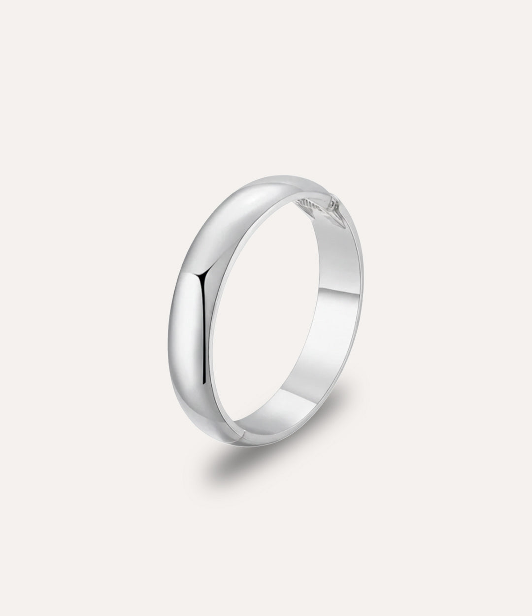 Essential Bangle in silver displayed on a neutral background with a sleek, minimalist bold design.