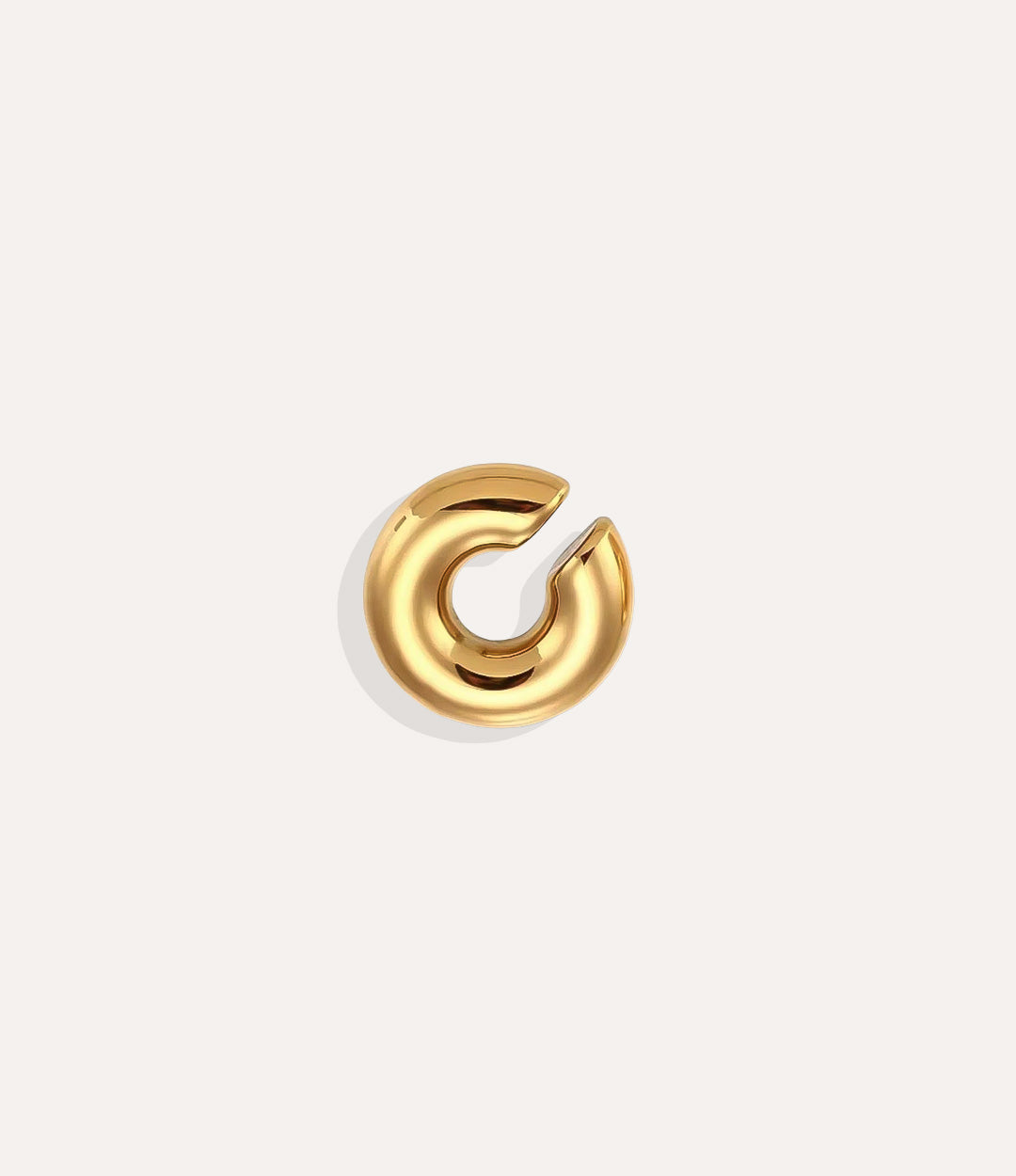 Product shot of the Essential Ear Cuff in gold tone displaying its smooth stainless steel finish and C-shaped design on a white background.