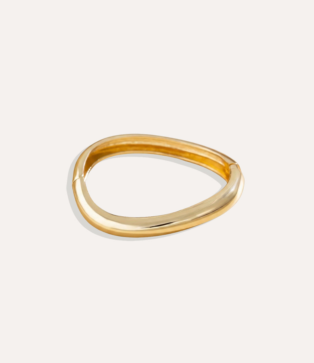 Gold Fluid Bangles with modern free-form design displayed on a clean background