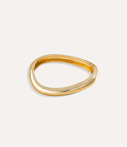 Gold Fluid Bangles with modern free-form design displayed on a clean background