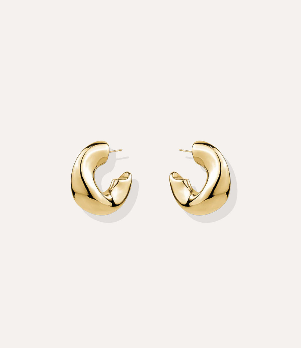 Close up of the Fluid Hoops in gold, highlighting the smooth curves and polished finish.