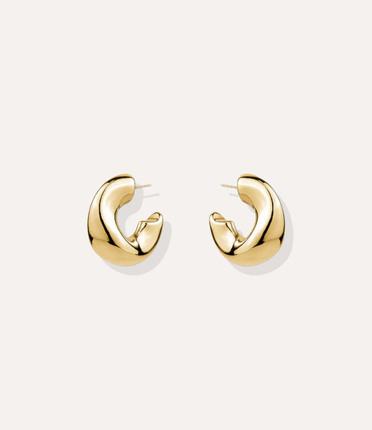 Close up of the Fluid Hoops in gold, highlighting the smooth curves and polished finish.